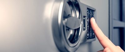 Woman,Opening,Steel,Safe,With,Electronic,Lock,,Closeup.,Banner,Design